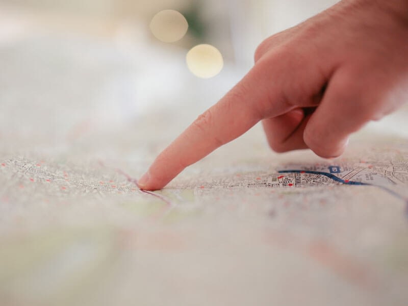 hand pointing at map